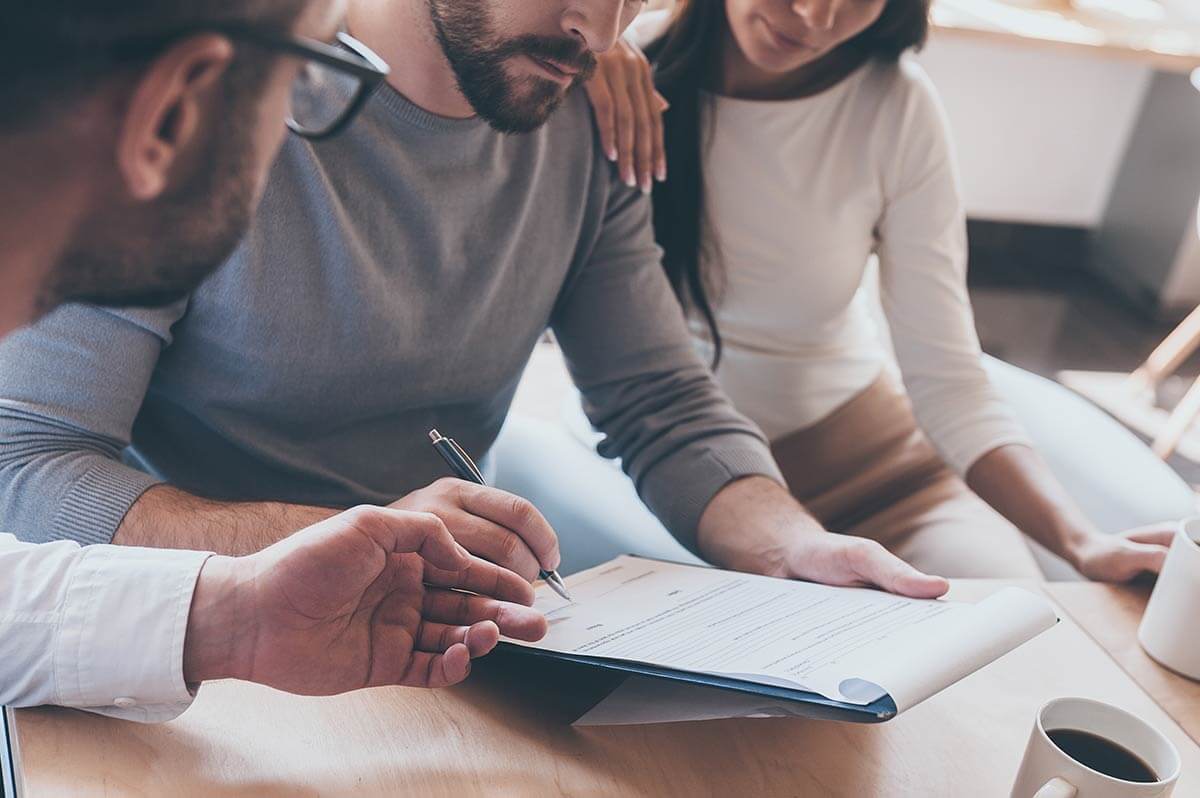 An attorney meeting with a man and woman